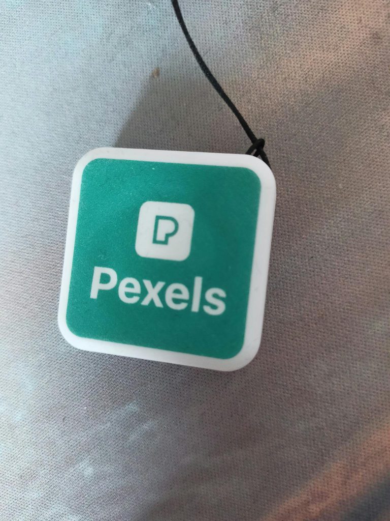 Close-up of a green Pexels logo on a white square background, symbolizing media and creativity.